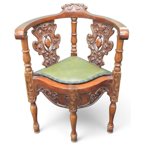 35 - A 19th century walnut framed corner chair with pair of carved pierced splats over green leatherette ... 