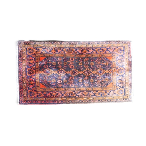 45 - A blue ground Hamadan rug with multicoloured geometric patterned ground within pink geometric floral... 
