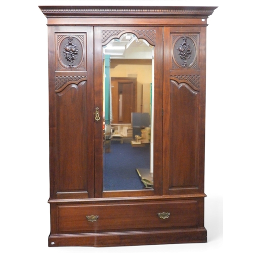 49 - An early 20th century mahogany veneered wardrobe with moulded dentil cornice over central bevelled g... 