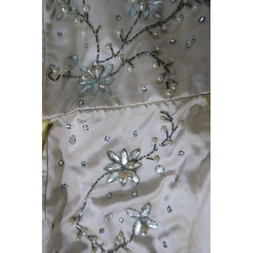 8000 - Circa 1950s ladies evening wear comprising a white fox stole, a silk gown with bead embroidery by Si... 