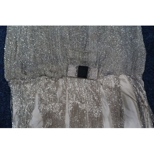 8003 - A 1920s flapper dress with scoop neckline, beaded drop waist silhouette and beaded fringe skirt, the... 