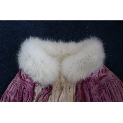 8005 - A circa 1930s pink silk velvet cape with white fox fur collar, lined with champagne satin; a blue si... 