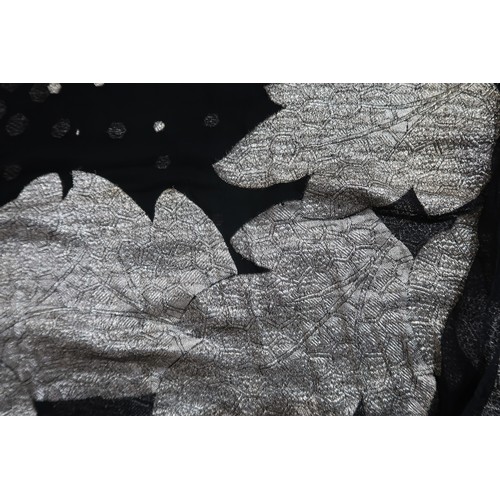 8020 - *Amended* A 1920s fur trimmed black cape by Reville London, a black shawl with silver lamé leaf-patt... 