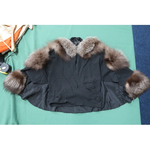 8020 - *Amended* A 1920s fur trimmed black cape by Reville London, a black shawl with silver lamé leaf-patt... 