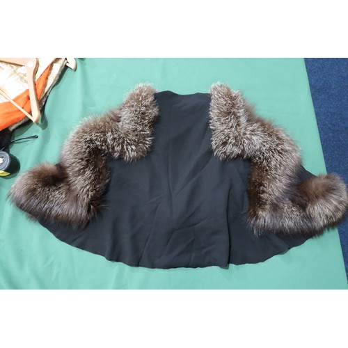8020 - *Amended* A 1920s fur trimmed black cape by Reville London, a black shawl with silver lamé leaf-patt... 