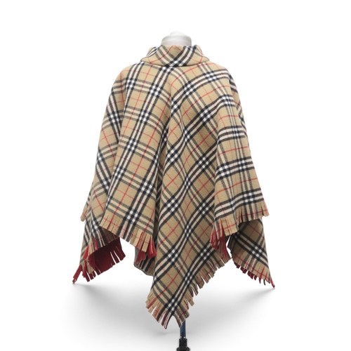 8034 - A Burberry wool poncho in nova check with red backing