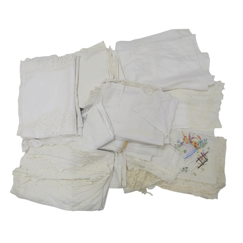 A collection of linens including embroidered and lace table linen, a ...