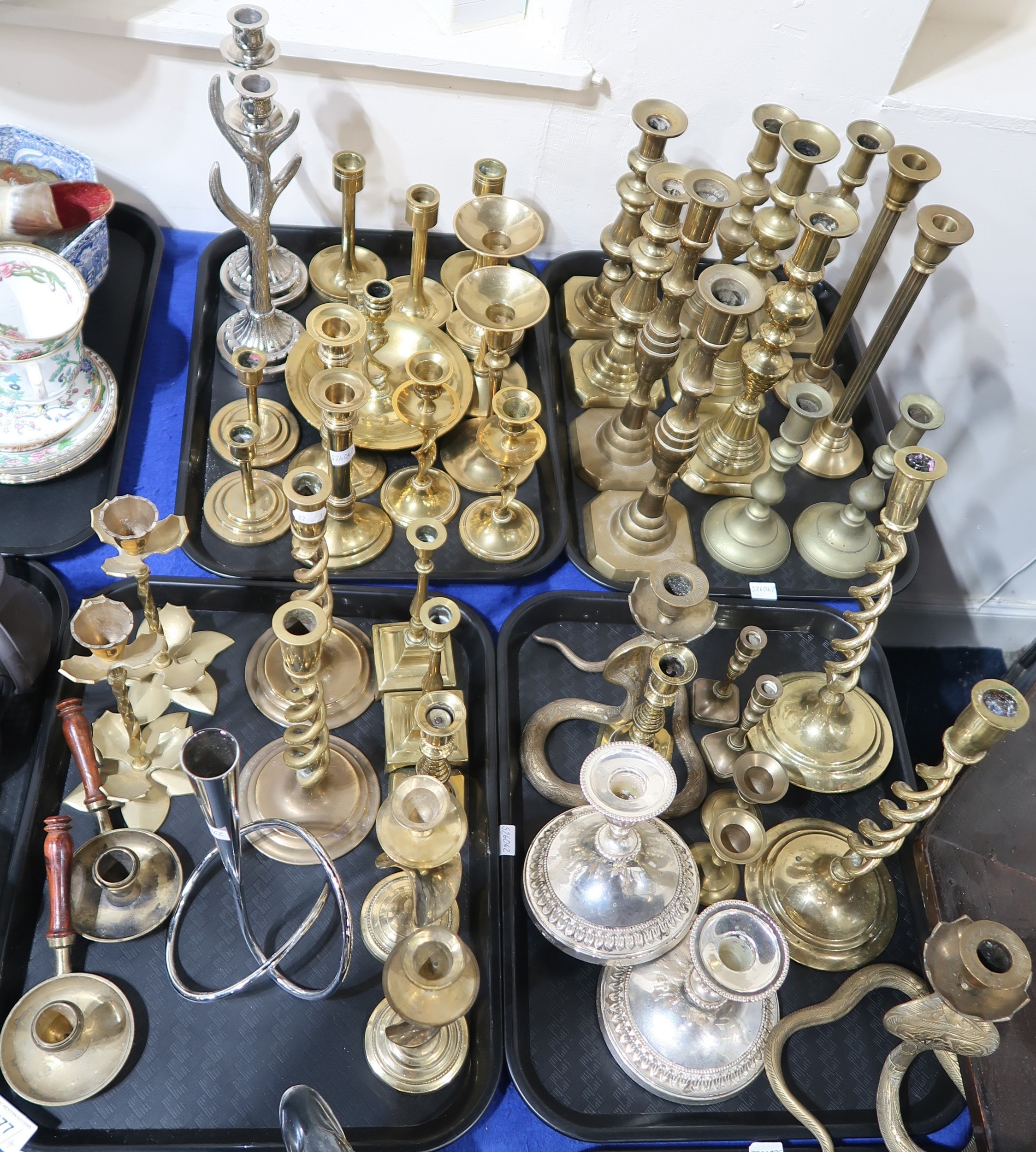 A quantity of brass and other candlesticks including a pair of snake ...