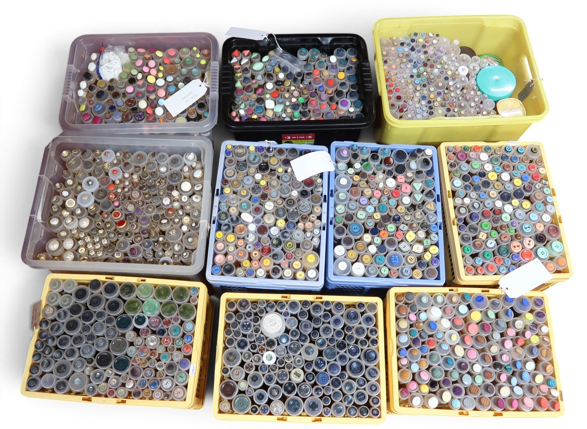 A large collection of buttons in a variety of colours and materials, in ...