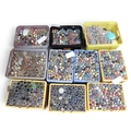 A large collection of buttons in a variety of colours and materials, in ...
