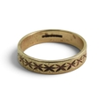 A 9ct gold wedding ring with a retro 1970's pattern, size V, weight 3.7gms