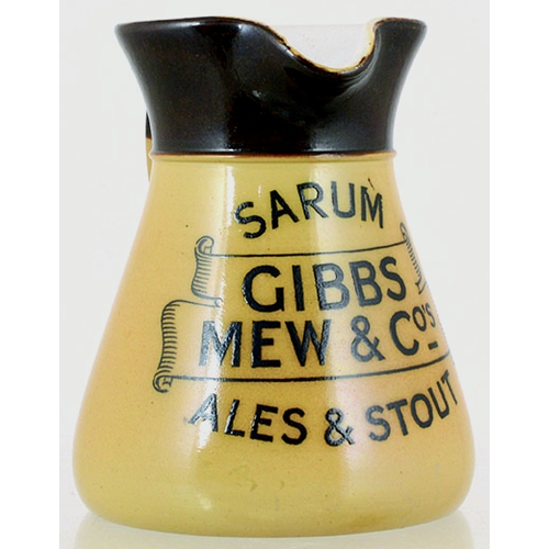 122 - GIBBS MEW & COS PUB JUG. 5.25ins tall, brown top, lower tan glaze. Rear handle, black transfer SARUM... 