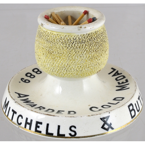 129 - MITCHELLS & BUTLERS MATCHSTRIKER. 3.5ins tall, all white with gold highlights. AWARDED GOLD MEDAL PA... 