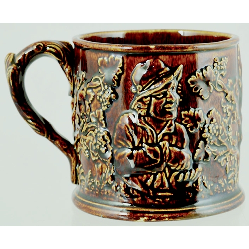 189 - FROG MUG. 4ins tall, dark, shiny treacle glaze, handled mug. Various sprigs, drinkers, topers & foli... 