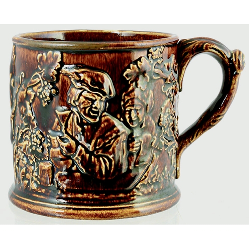 189 - FROG MUG. 4ins tall, dark, shiny treacle glaze, handled mug. Various sprigs, drinkers, topers & foli... 