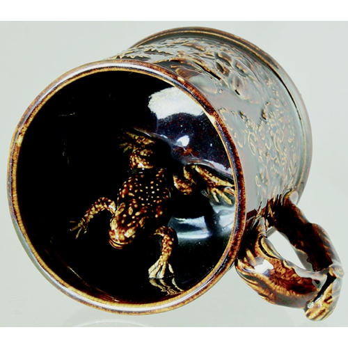 189 - FROG MUG. 4ins tall, dark, shiny treacle glaze, handled mug. Various sprigs, drinkers, topers & foli... 