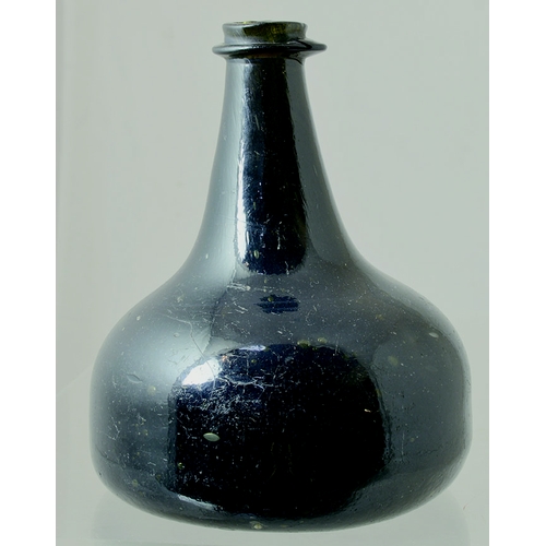 216 - SPLIT SIZE ENGLISH ONION. 5.4ins tall. Heavy black glass freeblown English onion, c. 1710. Crude ove... 