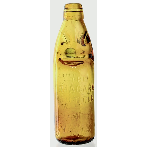 560 - NIAGARA PATENT CODD BOTTLE. 8.5ins tall. Burnt amber glass, aqua marble, embossed THE/ B/ MINERAL WA... 