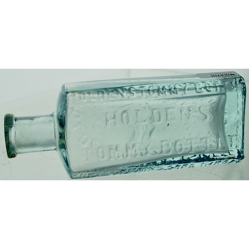 11 - Holdens Tommy Bottle. 4.3ins, ice blue glass, rectangular body, heavy, chamfered corners, delicate l... 