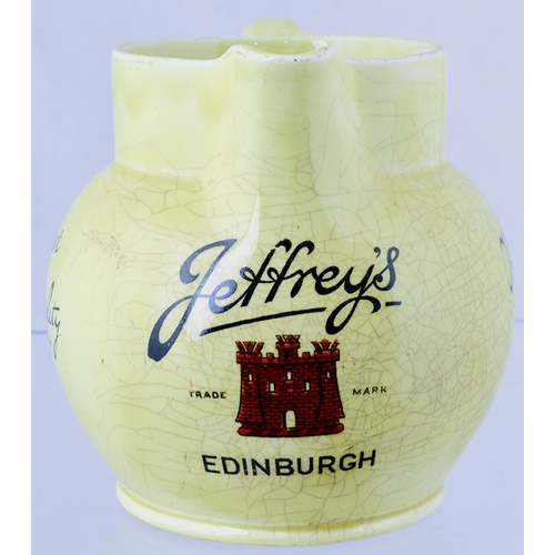 54 - JEFFREY’S EDINBURGH PUB JUG. 4.2ins tall, cream glaze, rear handle, black transfer with red castle t... 