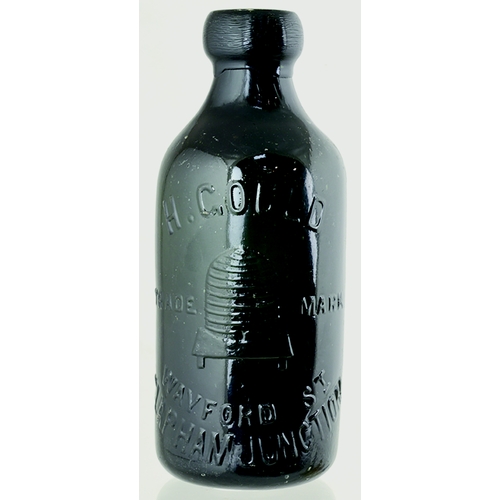 38 - CLAPHAM JUNCTION GLASS GINGER BEER. 6.75ins tall. Very dark green glass, heavily embossed H. GOULD/ ... 