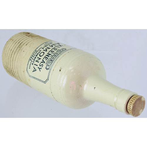 67 - DUNDEE AMMONIA BOTTLE. 11.25ins tall to top of stopper. Off white glaze, horizontal ribbing above & ... 