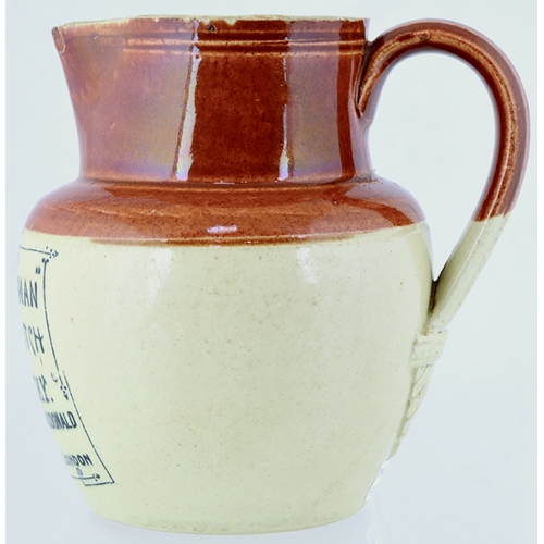 75 - THE SPORTSMAN WHISKY WATER JUG. 4.5ins tall. Tan top lower off white, rear handle, black transfer TH... 