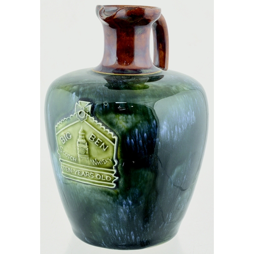 86 - BIG BEN ARTWARE WHISKY JUG. (WG pg 51) 7ins tall. Blue/ green mottled glaze, tan top & rear handle. ... 