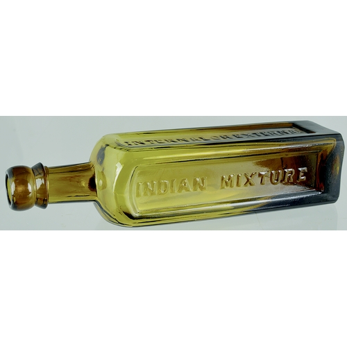 107 - INDIAN MIXTURE CURE BOTTLE. 8.5ins tall. Sauce bottle shape, amber glass, facetted panels, embossed ... 