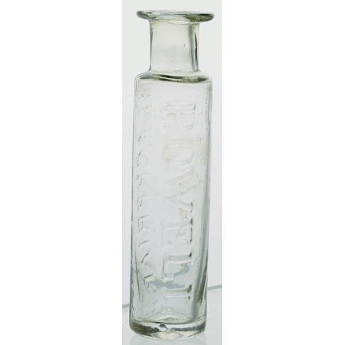 105 - FLINT GLASS CURE BOTTLE. 4ins tall. Clear glass, cylindrical shape, flared lip, embossed POWELL/ BLA... 