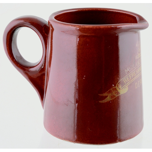 601 - DERBY RAILWAY CREAM JUG. 2ins tall. Brown body glaze, rear handle. Front transfer MIDLAND RAILWAY/ R... 