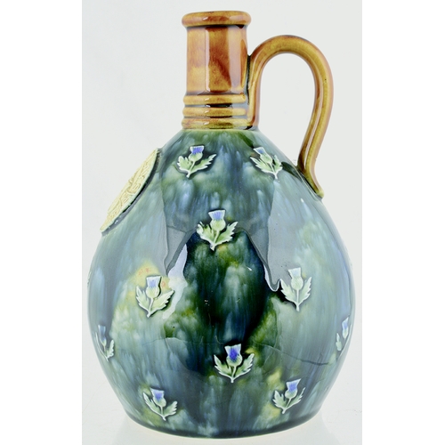 629 - MACKINLAYS SCOTCH WHISKY JUG. (WG p 120) 8ins tall. Artware jug with applied front plaque for MACKIN... 