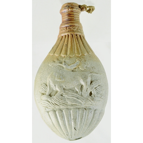 740 - POWDER FLASK. 8ins tall. Variating tan salt glaze, modelled as a gun powder-flask, decorated either ... 