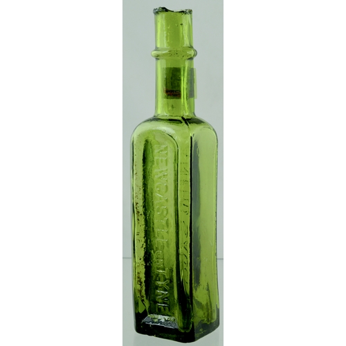 71 - NEWCASTLE SAUCE BOTTLE. 8ins tall. Pale olive green glass, rectangular shape, sheard lip, embossed t... 