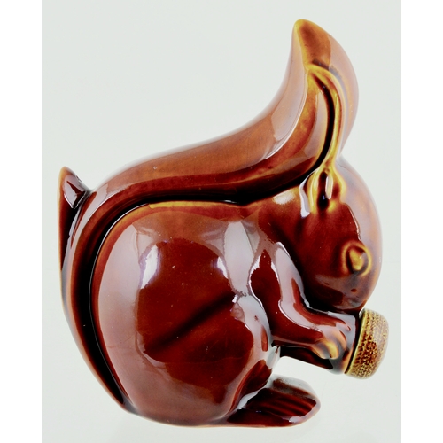 600 - VELRAY POTTERY HOT WATER BOTTLE. 8ins tall. Dark tan glaze, modelled as a squirrl eating an acorn. A... 