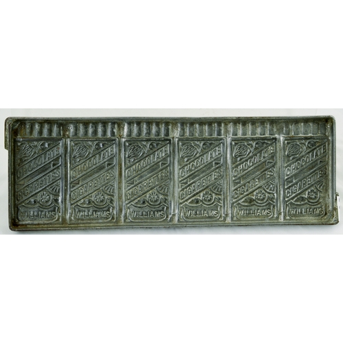 648 - CHOCOLATE MOULD. 10 by 3.5ins. Metal mould for CHOCOLATE/ CIGARETTES/ WILLIAMS with cocoa bean detai... 