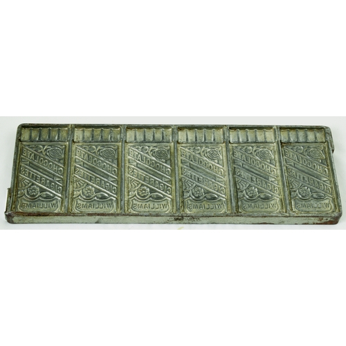 648 - CHOCOLATE MOULD. 10 by 3.5ins. Metal mould for CHOCOLATE/ CIGARETTES/ WILLIAMS with cocoa bean detai... 