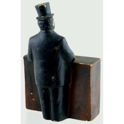 653 - BURTONWOOD STRONG ALE TIP BOX. 6.75ins tall. Rubberoid construction of top hatted gent stood at bar,... 