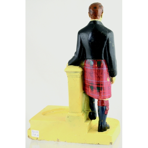 654 - GRANTS 8 BACK BAR FIGURE. 13.5ins tall. Plaster figure of kilted gent stood aside pillar & area for ... 