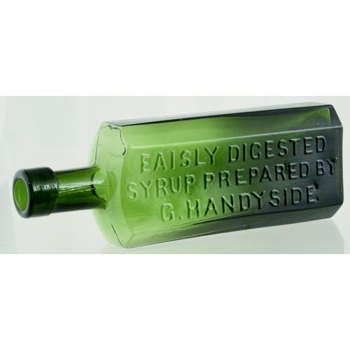 664 - G. HANDYSIDE BOTTLE. 7ins tall. Variating dark green glass, rectangular, chamfered corners. Front pa... 