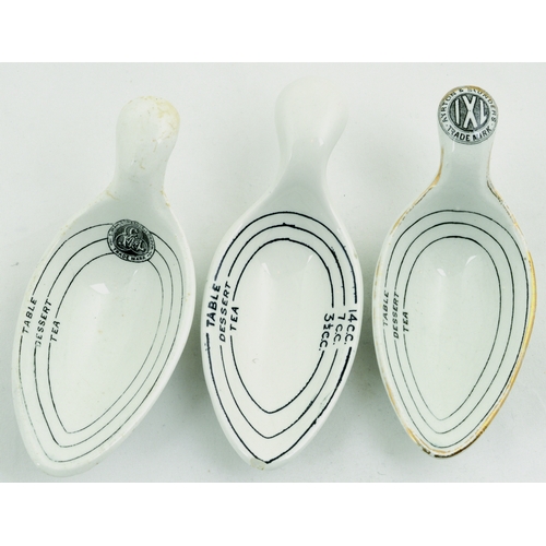 673 - CERAMIC MEASURING SPOONS TRIO. Largest 4.5ins long. All white glaze with black transfers, line marks... 