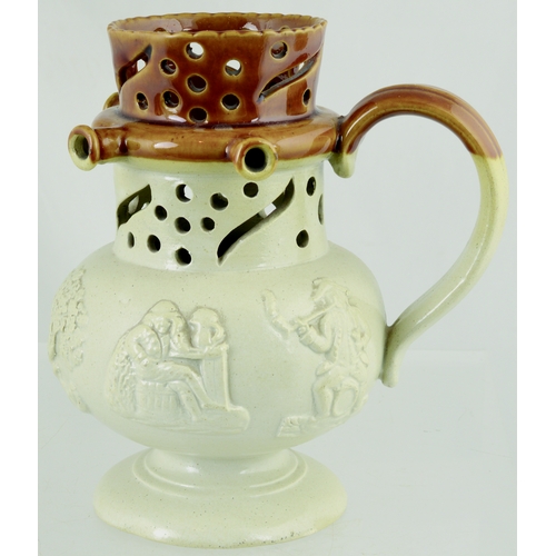 716 - PUZZLE JUG. 6.5ins tall. Rotund bellied cylindrical jug, brown top, off white lower section, rear ha... 