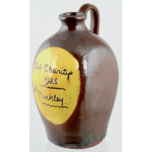 712 - DATED BUCKLEY FLAT SIDED FLASK. 7.5ins tall. Dark tan main body glaze, front inscribed BOB CHARITY/ ... 