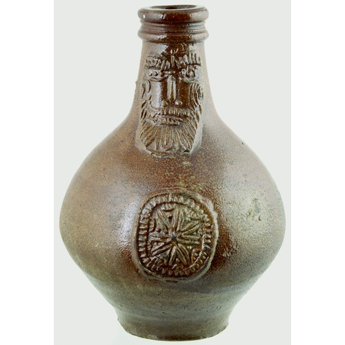 701 - BELLARMINE. 8.5ins tall. Bulbous bodied Bellarmine jug in brown tiger glaze, bearded face to neck, d... 