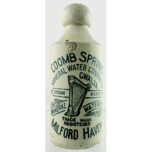 47 - MILFORD HAVEN MINERAL WATER BOTTLE. 7ins tall, all white, st, black transfer, COOMB SPRING/ MINERAL ... 