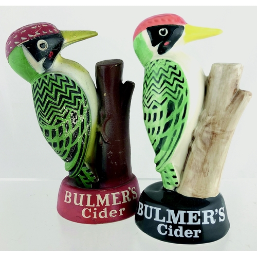 58 - BULMERS CIDER DUO. 8ins tall. Two variations of multicoloured woodpecker figures, one ceramic (Carlt... 