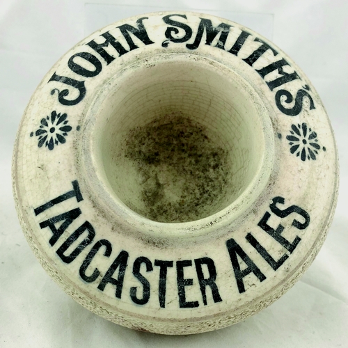 397 - JOHN SMITH’S TADCASTER ALES MATCHSTRIKER. 2.5ins tall, cream glaze, black lettering, circular body w... 