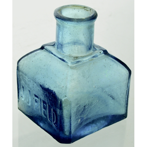 562 - BLUE FIELDS INK. 2.75ins tall. Blue glass, square shape, rounded corners. Embossed one side J J FIEL... 