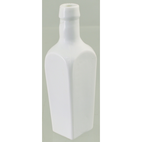 612 - MINIATURE MILK GLASS BITTERS BOTTLE. 4ins tall. Tapered rectangular shape, rounded shoulders embosse... 