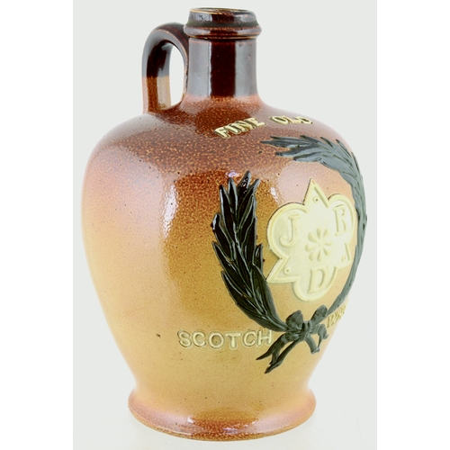 620 - J.R.D. SCOTCH WHISKY JUG. (WG p 157) 7ins tall. Variating tan salt glaze, rear handle, applied front... 